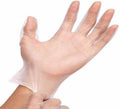 Hand wearing a transparent powder free vinyl glove for medical and household use